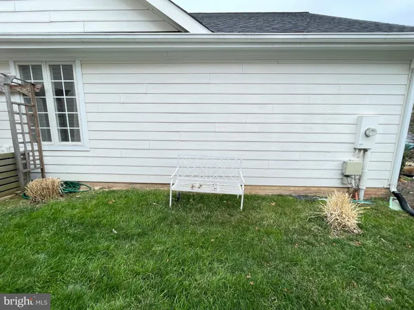 a view of a house with yard and sitting area