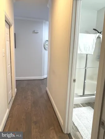 a view of hallway with wooden floor