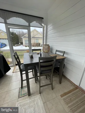 a kitchen with stainless steel appliances granite countertop a dining table chairs and granite counter tops