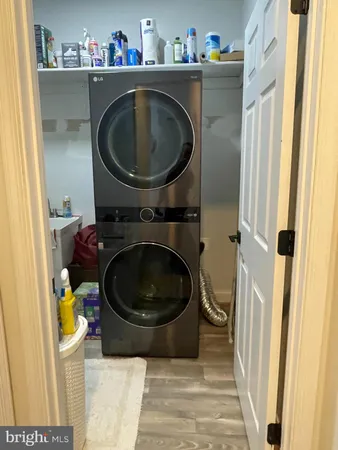 a kitchen with stainless steel appliances granite countertop a refrigerator a stove a sink and white cabinets