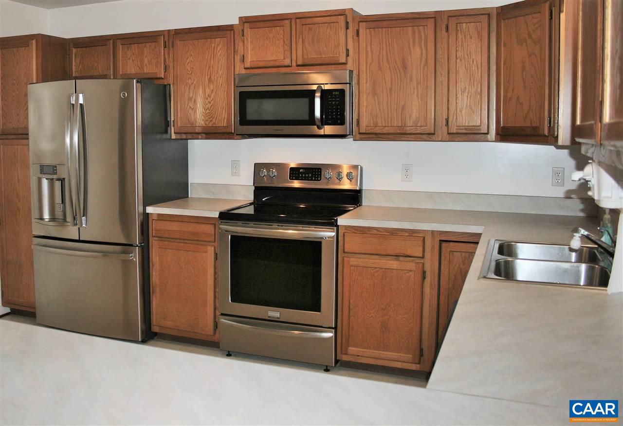 102 Thacker Road Mineral, VA 23117 - Photo 4 of 25 a kitchen with stainless steel appliances wooden cabinets and a stove top oven