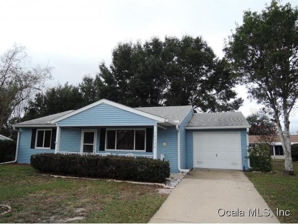 10934 Southwest 86th Court Ocala, FL 34481 - Photo 1 of 1 a front view of a house with a garden