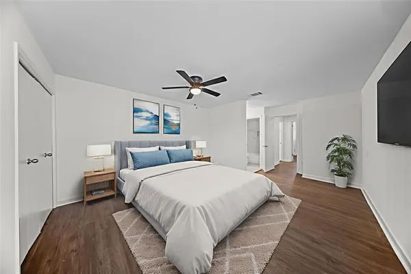 a bedroom with a large bed and a chandelier