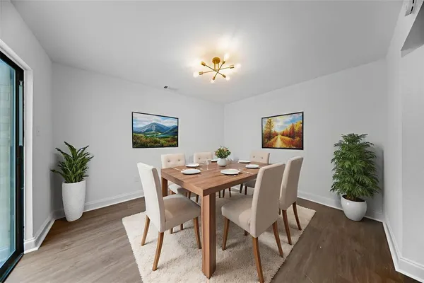 a view of a dining room with furniture and wooden floor