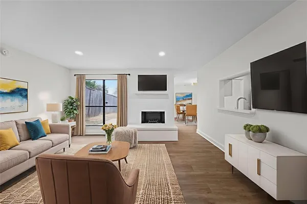 a living room with furniture fireplace and flat screen tv