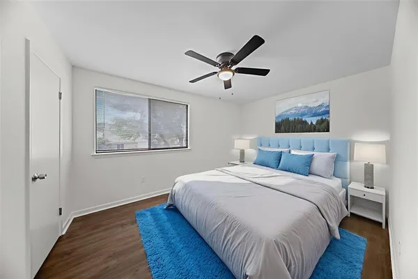 a bedroom with a bed and painting on the wall
