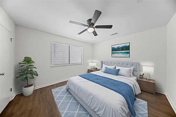 a bedroom with a bed and a potted plant