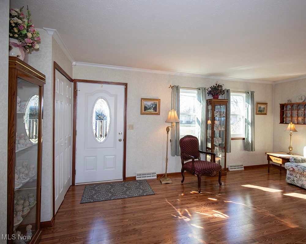 1614 South Abbe Road Elyria, OH 44035 - Photo 7 of 35 Entrance foyer featuring visible vents, plenty of natural light, wood finished floors, and crown molding