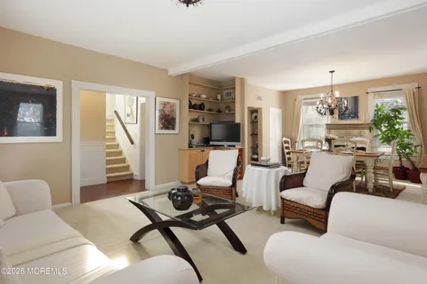 a living room with furniture rug and wooden floor