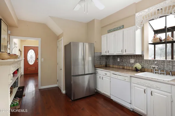 a kitchen with a refrigerator sink and cabinets
