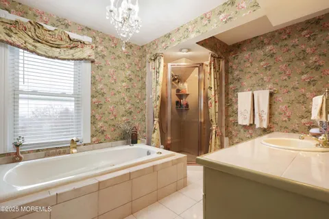 a spacious bathroom with sink and a bathtub