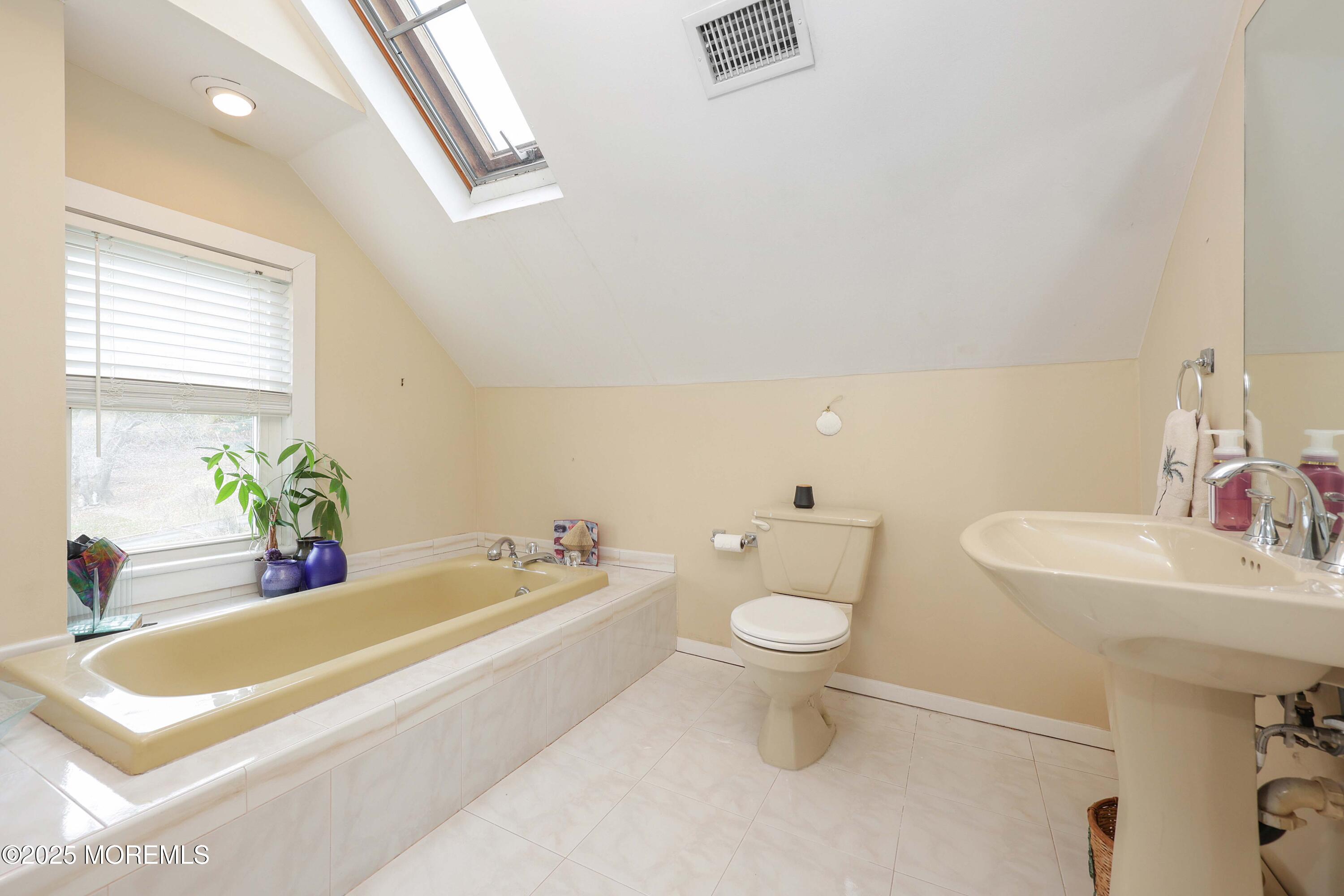 75 Portland Road Highlands, NJ 07732 - Photo 31 of 56 a bath room with a toilet a sink and a bath tub