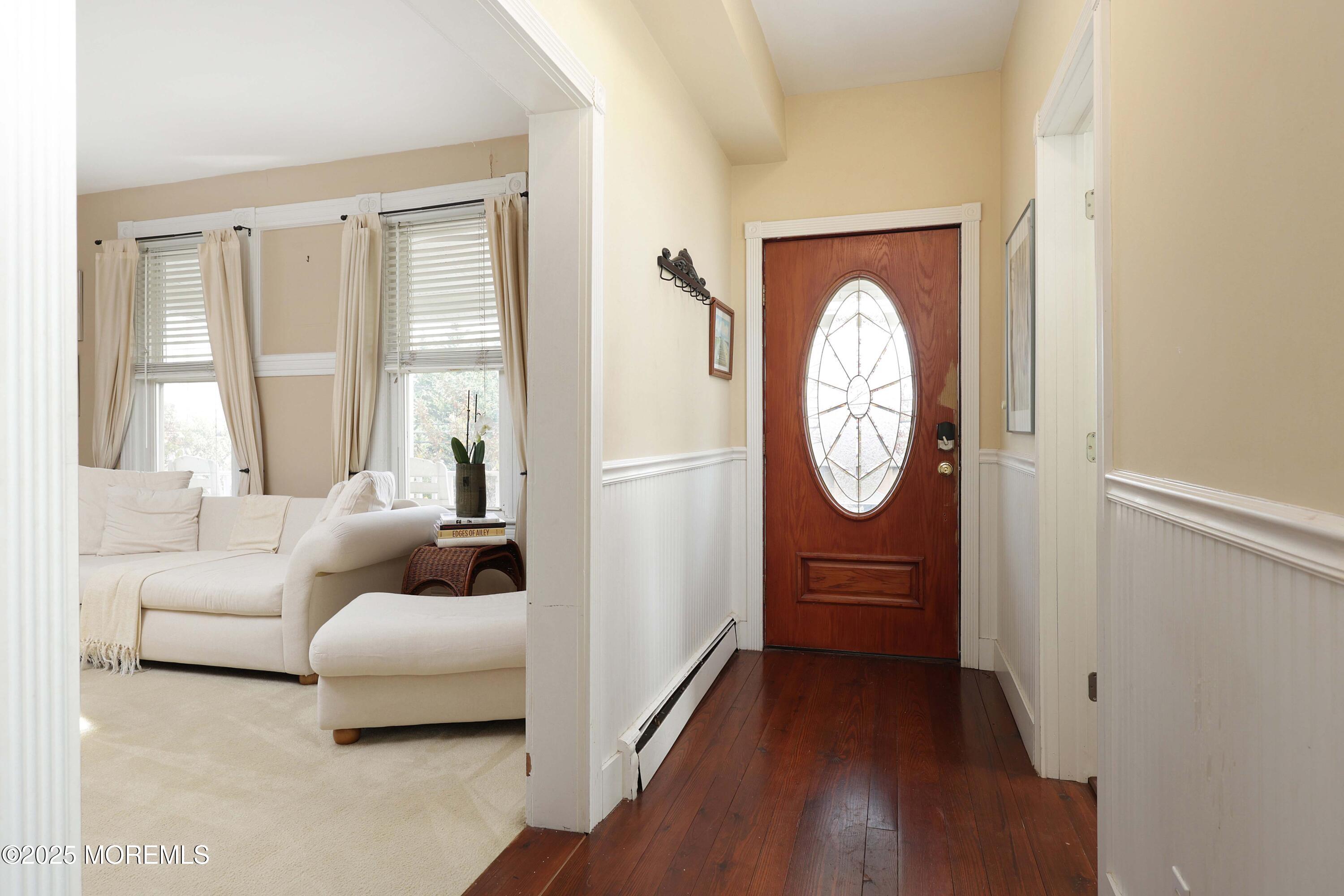 75 Portland Road Highlands, NJ 07732 - Photo 6 of 56 a living room with furniture a large window and wooden floor