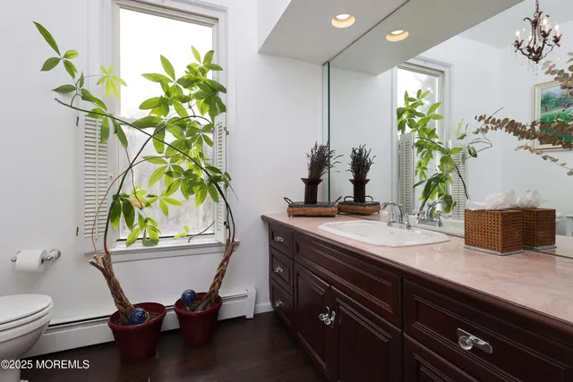 a bath room with a sink and a mirror