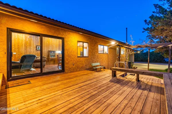a view of a balcony with wooden floor and fence