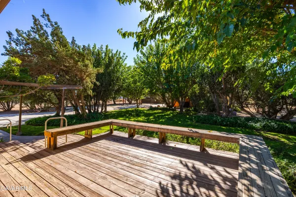 a view of yard with swimming pool and green space