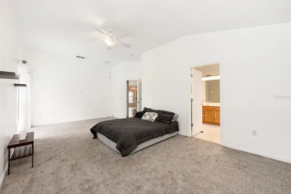 a bedroom with a bed and cabinets
