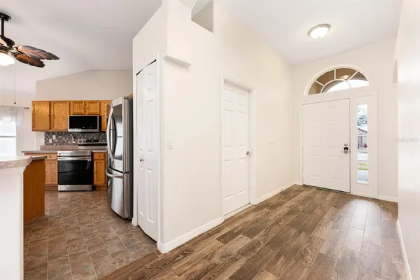 a view of a kitchen with a sink stove refrigerator and microwave