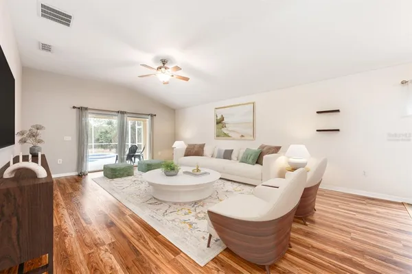 a view of a dining room with furniture a chandelier and wooden floor