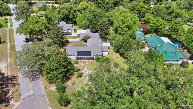 an aerial view of a house with a yard