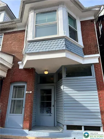 a view of a house with a door and a window