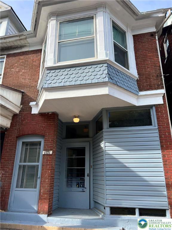 a view of a house with a door and a window