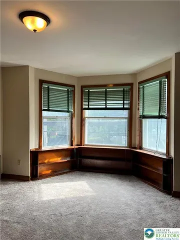 an empty room with large window