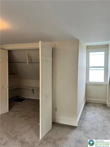 a view of an empty room and a windows