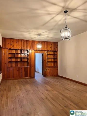 a view of a room with furniture and wooden floor