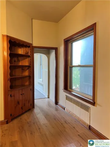 an empty room with windows and closet