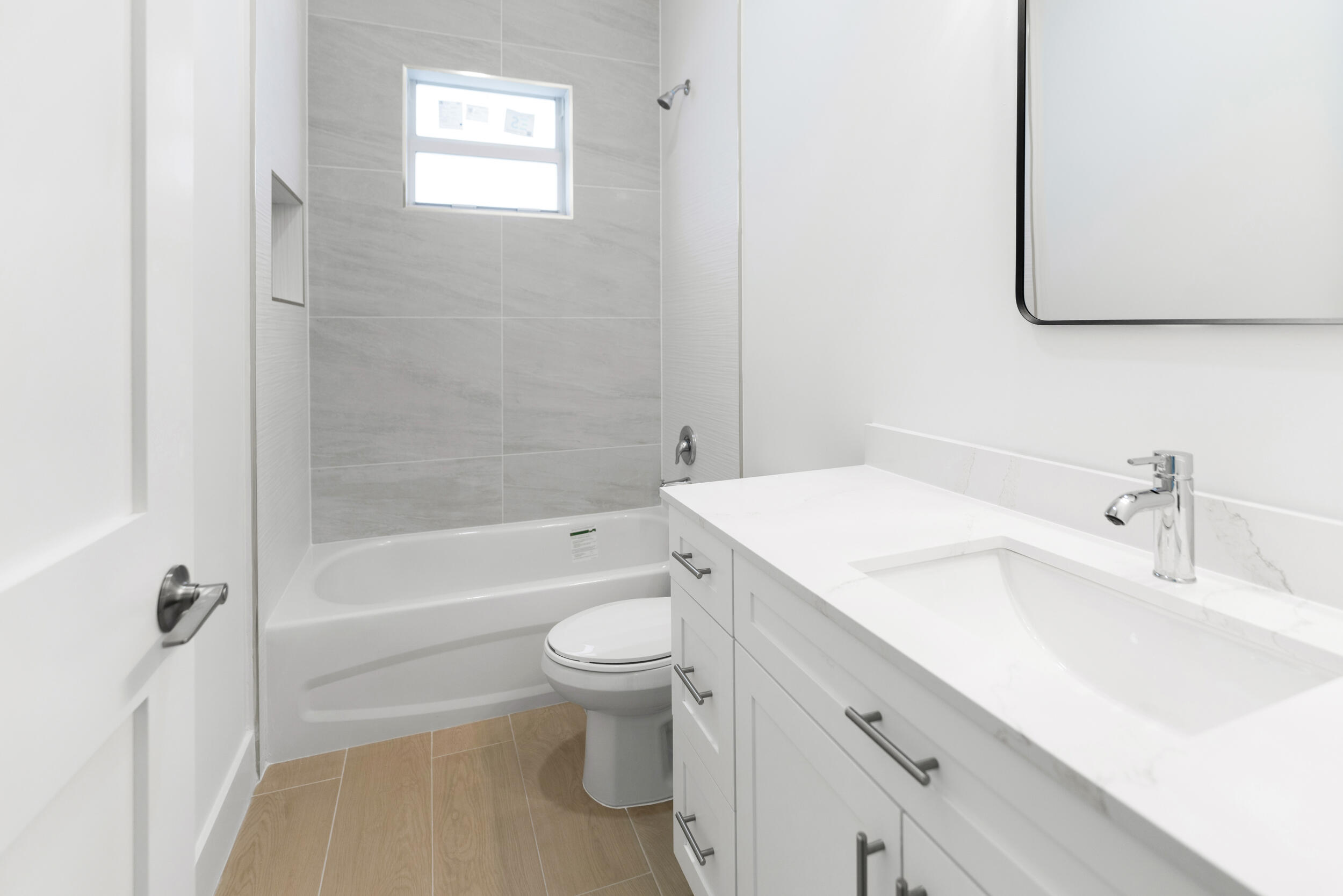 4641 Northview Drive Jupiter, FL 33458 - Photo 12 of 22 a bathroom with a sink toilet vanity and bathtub