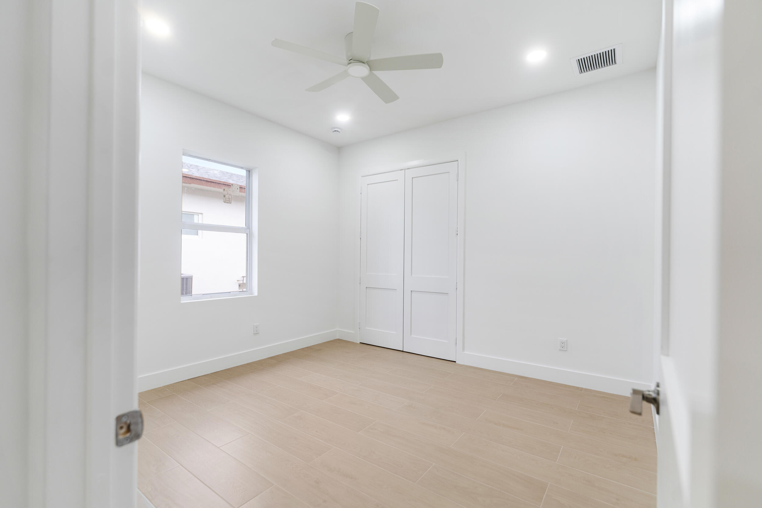 4641 Northview Drive Jupiter, FL 33458 - Photo 15 of 22 an empty room with a window and a ceiling fan