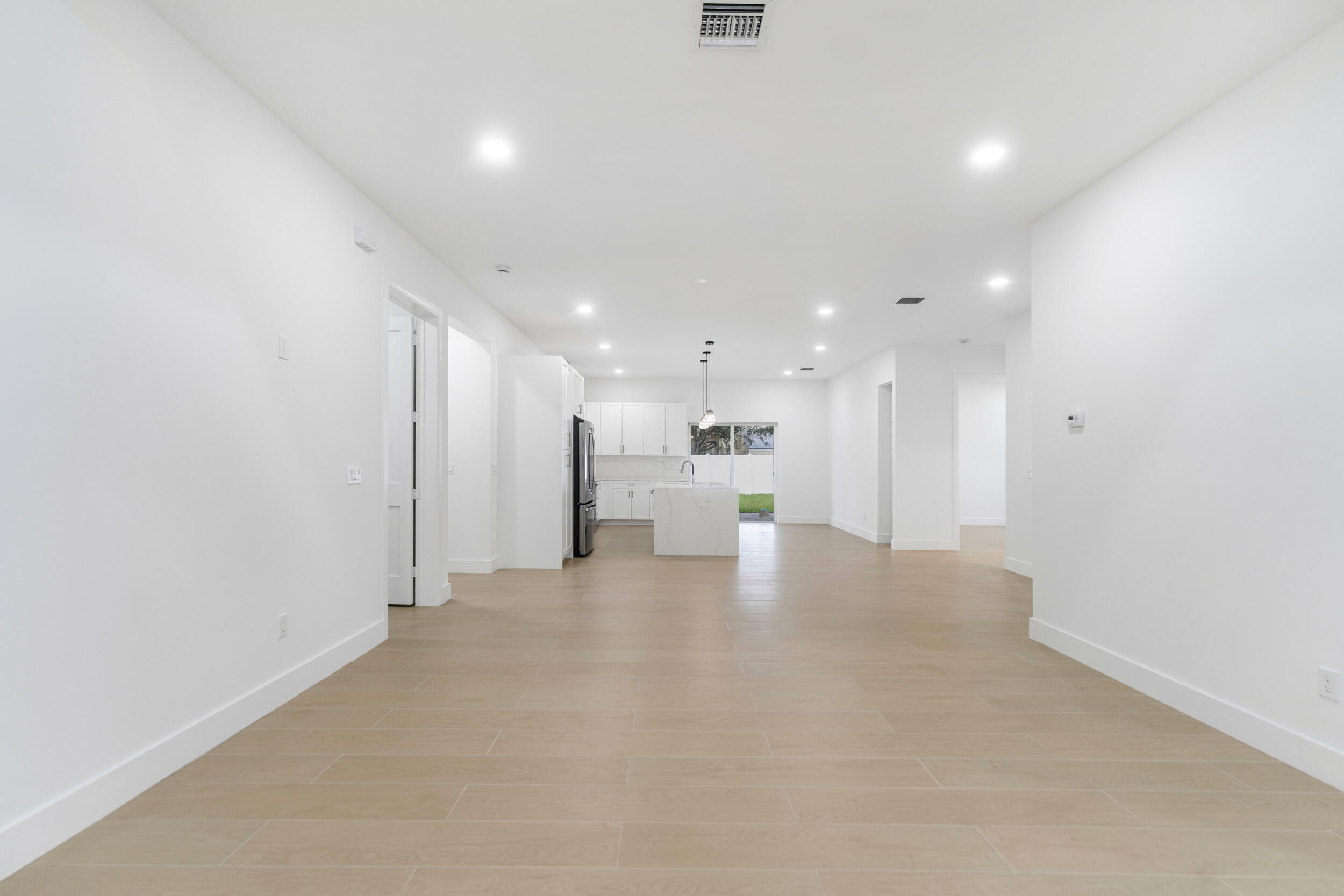 4641 Northview Drive Jupiter, FL 33458 - Photo 2 of 22 a view of a kitchen with a refrigerator and a sink