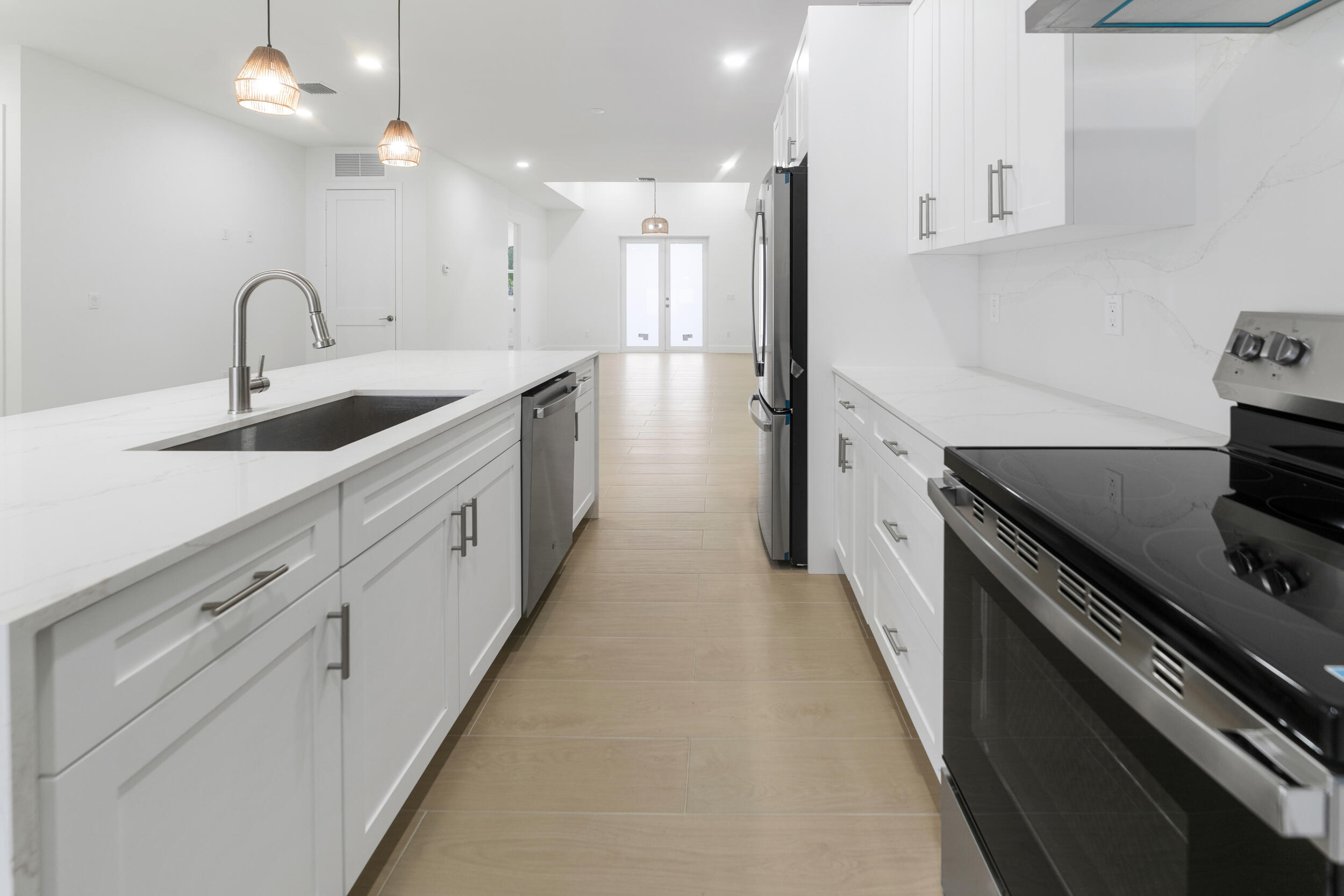 4641 Northview Drive Jupiter, FL 33458 - Photo 6 of 22 a kitchen with sink a stove and cabinets