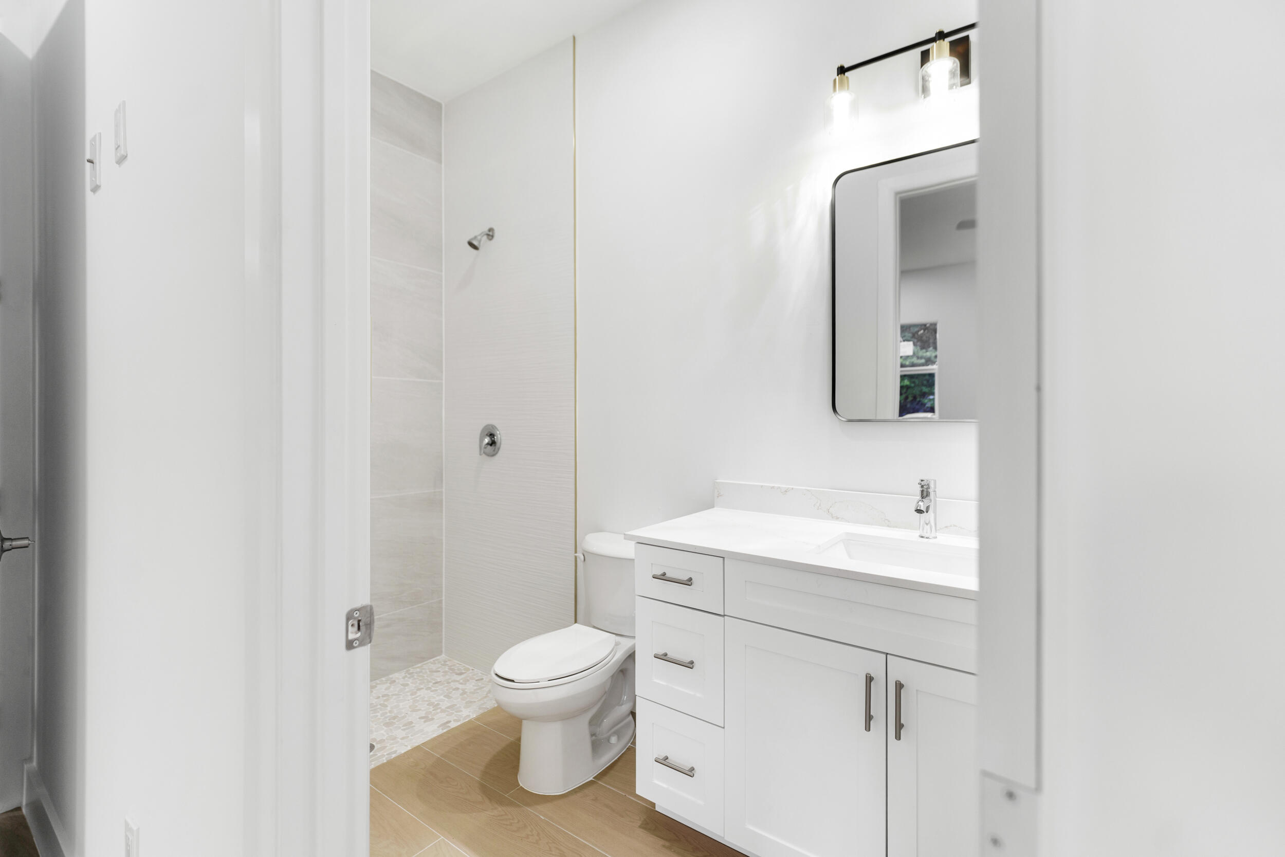 4641 Northview Drive Jupiter, FL 33458 - Photo 7 of 22 a bathroom with a toilet sink and mirror