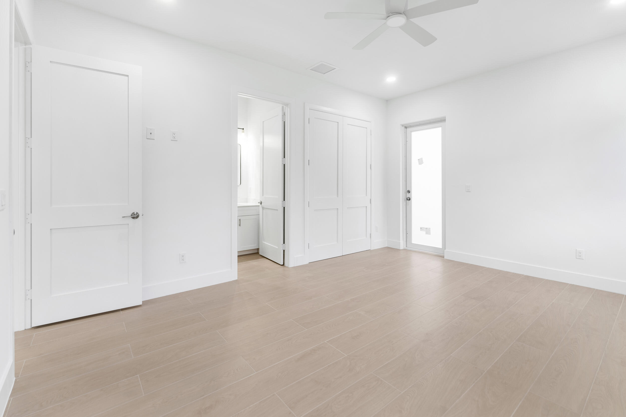 4641 Northview Drive Jupiter, FL 33458 - Photo 10 of 22 an empty room with chandelier fan and windows