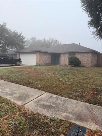 a view of a lake with a big yard and large trees