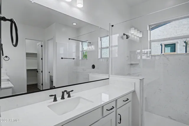 a bathroom with a sink double vanity and a mirror