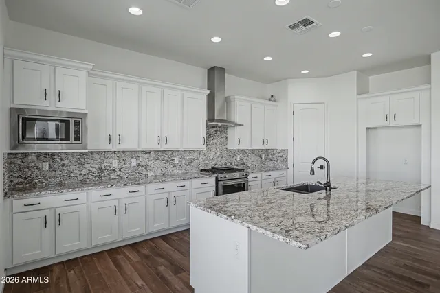 a view of kitchen with cabinets and wooden floor