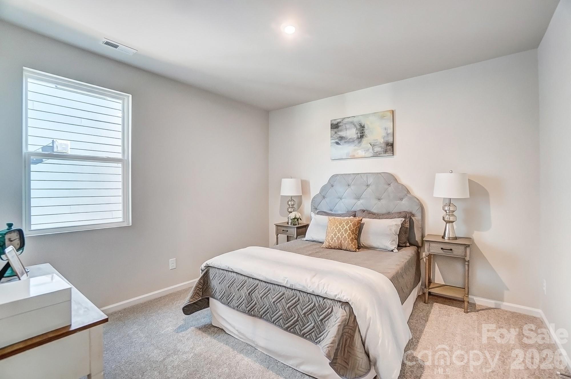 1456 McCollum Street Monroe, NC 28112 - Photo 20 of 29 a bedroom with a large bed and a window