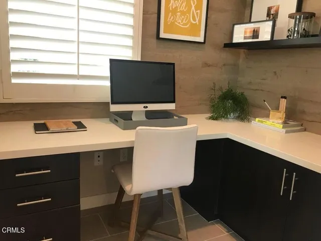 a kitchen with granite countertop cabinets and black appliances
