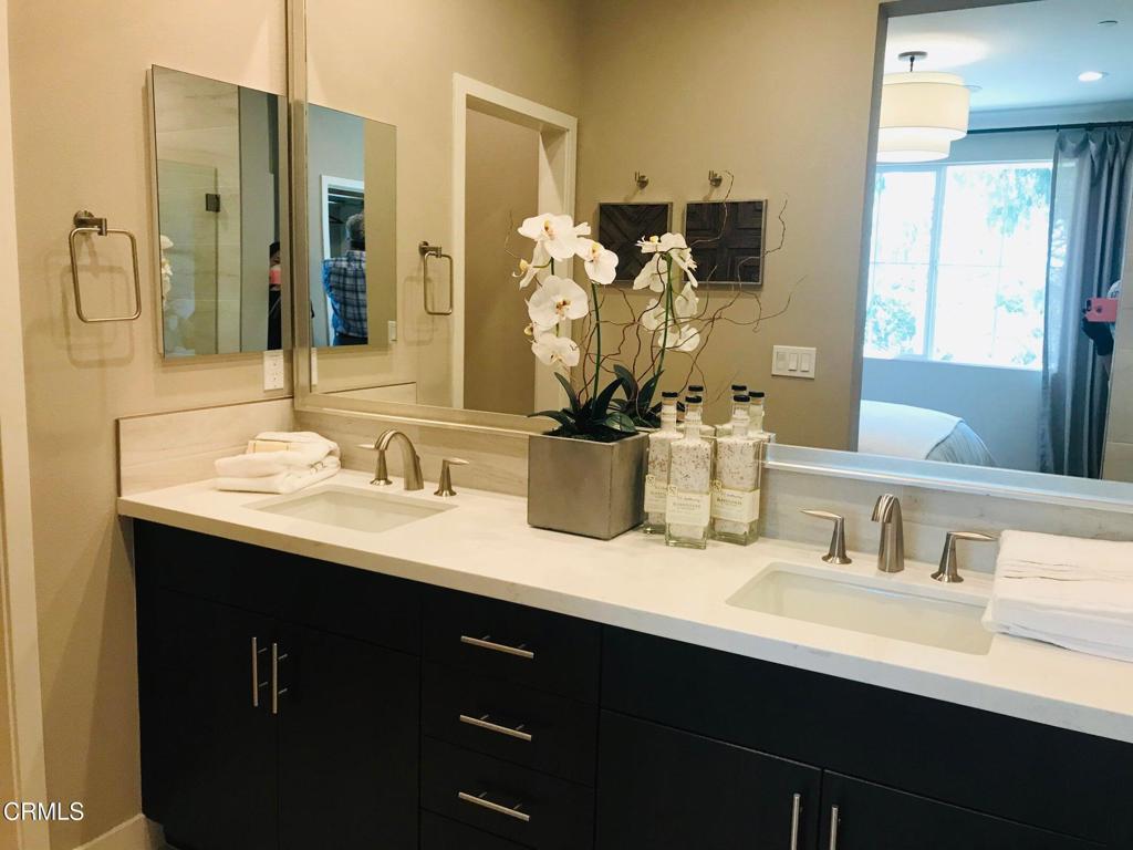 5663 Surfrider Way, Unit 101 Goleta, CA 93117 - Photo 15 of 54 a bathroom with double sink and a mirror