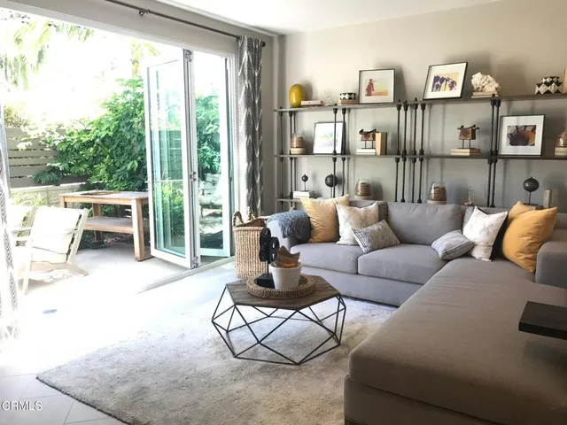 a living room with furniture and a floor to ceiling window