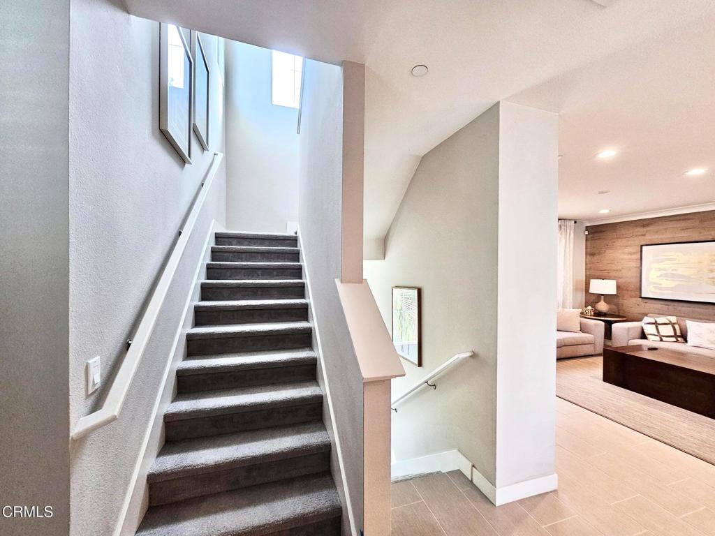 5663 Surfrider Way, Unit 101 Goleta, CA 93117 - Photo 29 of 54 a view of a hallway with stairs and furniture
