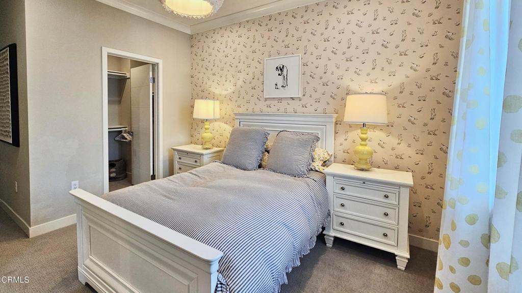 5663 Surfrider Way, Unit 101 Goleta, CA 93117 - Photo 41 of 54 a bedroom with a bed and cabinets