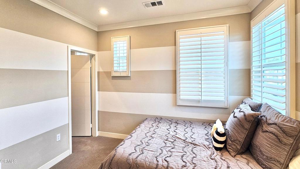 5663 Surfrider Way, Unit 101 Goleta, CA 93117 - Photo 46 of 54 a bedroom with a bed and wooden floor