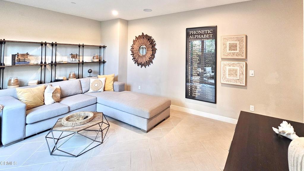 5663 Surfrider Way, Unit 101 Goleta, CA 93117 - Photo 48 of 54 a living room with furniture and painting on the wall