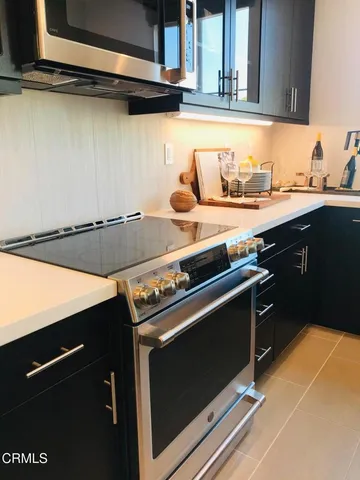 a stove top oven sitting inside of a kitchen