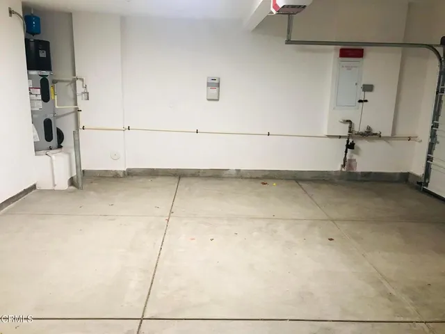 a living room with furniture potted plant and a large window