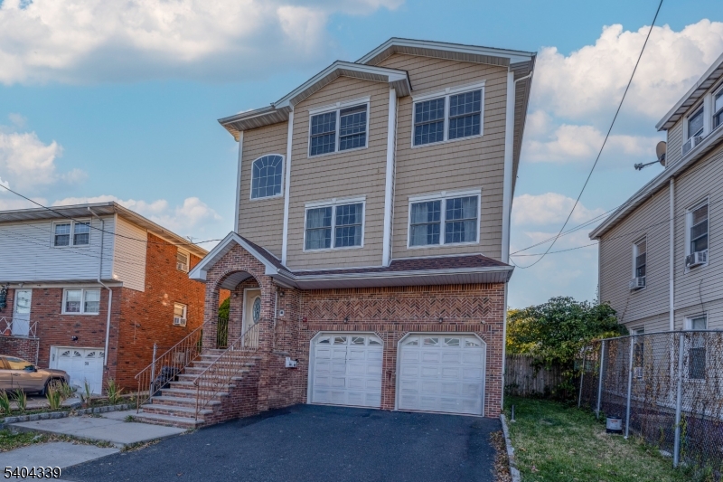 307 Pearl Street Elizabeth, NJ 07202 - Photo 1 of 13 a front view of a house with a yard